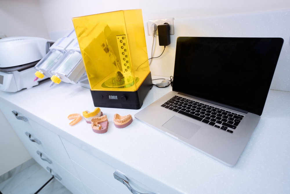 Dental professional using advanced digital scanning and 3D printing technology to create orthodontic appliances, supporting advanced orthodontic technology, an orthodontist in Melbourne and patients considering adult braces.